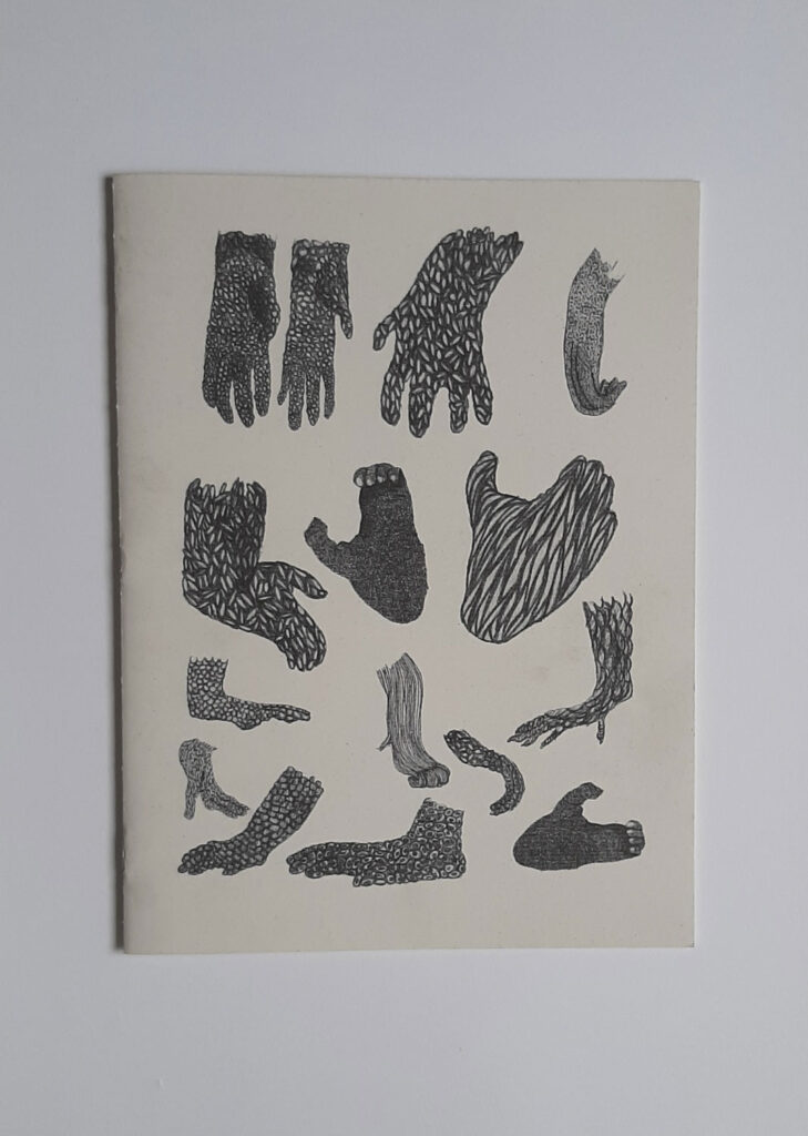 Cover of a zine with various hand or claw like drawings in black. 