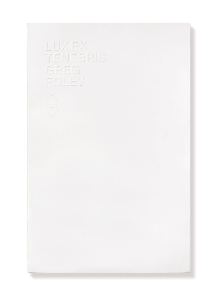 Blank white folio with embossed text that reads "Lux Ex Tenebris Greg Foley"