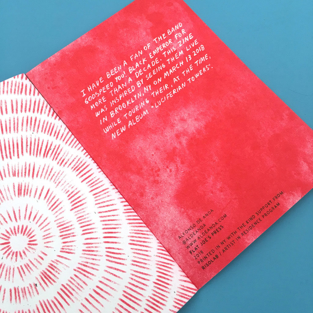 Spread from a zine, the left page is many short red lines arranged in concentric circles, and the right page is a red textured background with white handwritten  text. 
