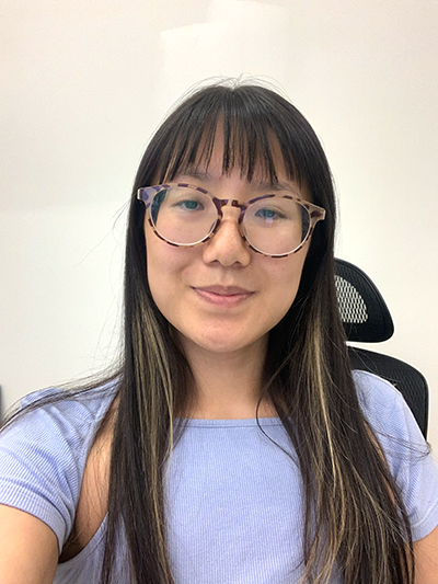 Photo of Sarula Bao, who has long black hair, glasses and a blue shirt.