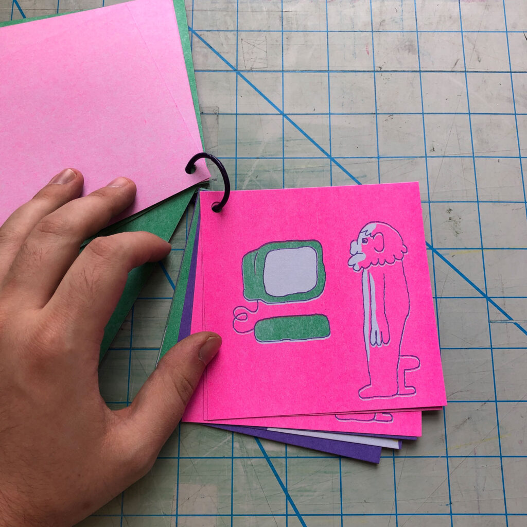 A page from the small square book, of a figure facing a green computer, against a pink background. 