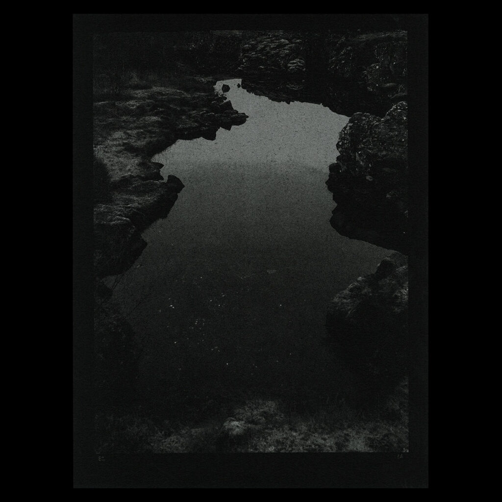 Dark photograph of some natural land formations and rocks.