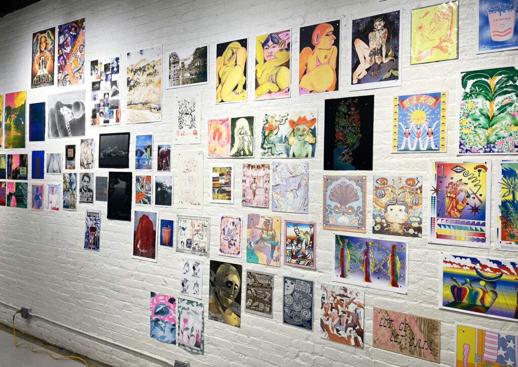 Photo of "Printing the Future" exhibition, showing prints arranged on the wall salon style.