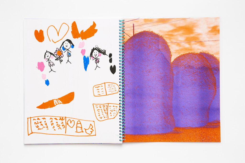 Double page spread with a childs drawing of books and figures on the left page, and a purple and orange posterized photo of grassy mounds on the right page.