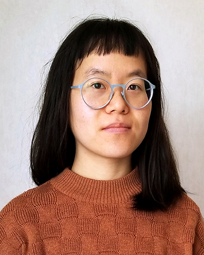 Headshot of JooHee Yoon, a Korean woman with black, shoulder length hair, short bangs and pale round glasses.